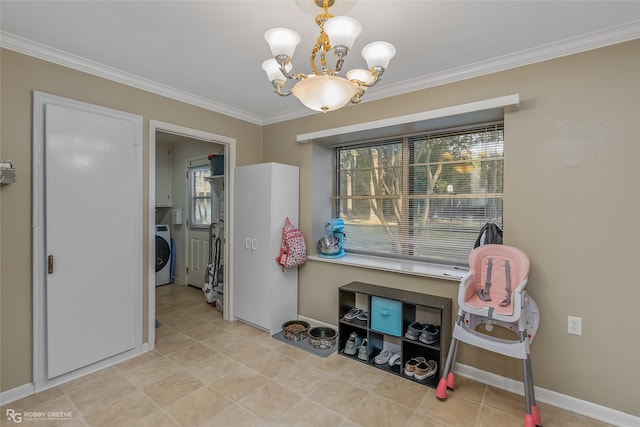 interior space with washer / dryer, crown molding, and a chandelier