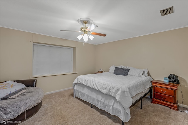 carpeted bedroom featuring ornamental molding and ceiling fan