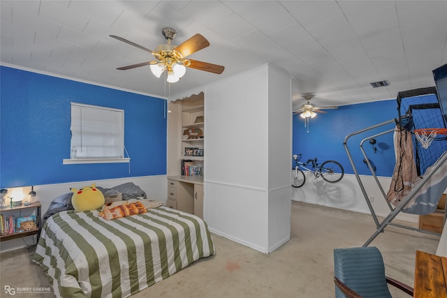 carpeted bedroom with ceiling fan and ornamental molding