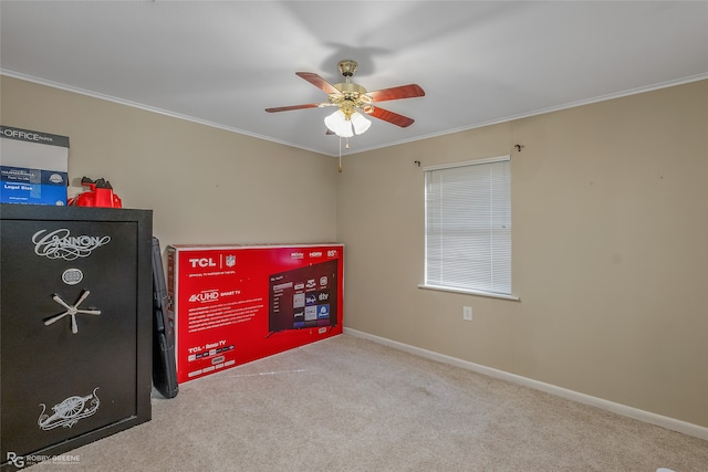 carpeted empty room featuring ornamental molding and ceiling fan