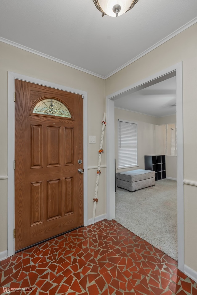 entryway featuring carpet floors and ornamental molding