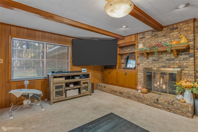 carpeted living room with a brick fireplace, beamed ceiling, and wooden walls