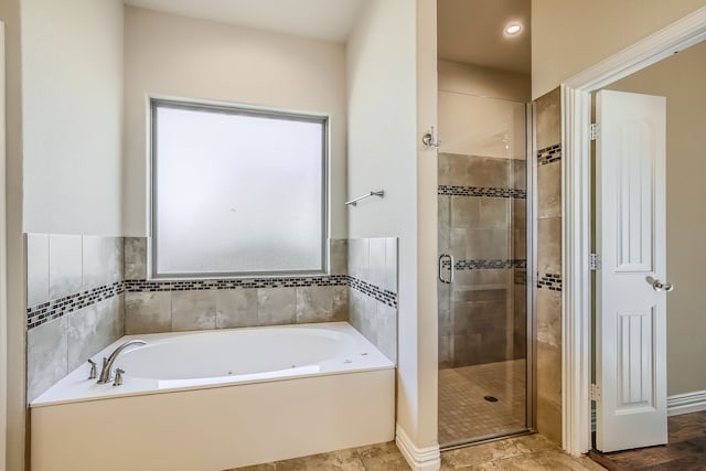 bathroom featuring independent shower and bath