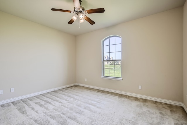 empty room featuring light carpet and ceiling fan