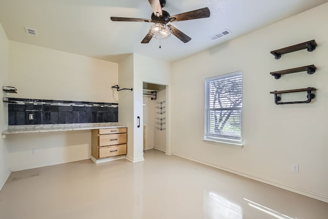 bathroom with ceiling fan and concrete floors