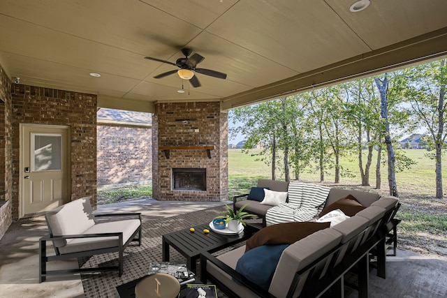 view of patio featuring ceiling fan and an outdoor living space with a fireplace