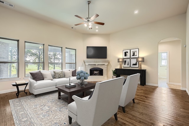 living room with ceiling fan and dark hardwood / wood-style flooring