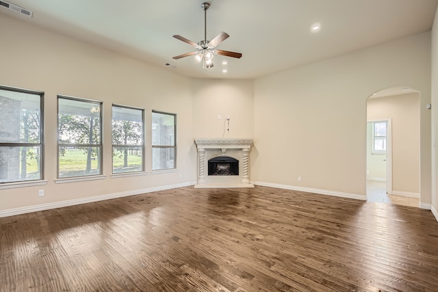 unfurnished living room with ceiling fan and dark wood-type flooring