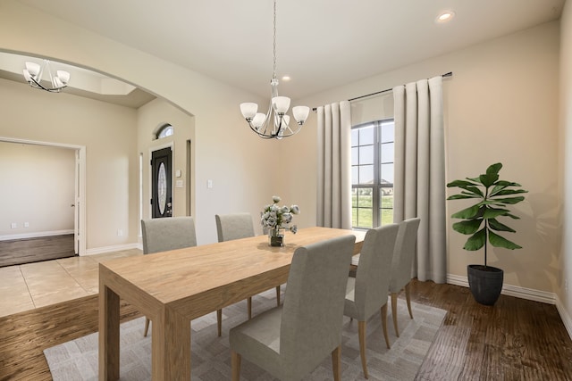 dining room with a notable chandelier and wood-type flooring