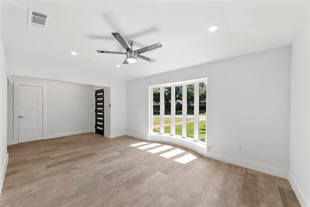 empty room featuring light hardwood / wood-style flooring and ceiling fan