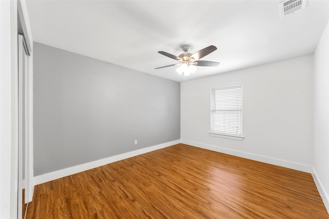 unfurnished room with ceiling fan and wood-type flooring