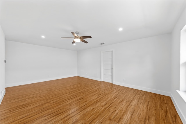 empty room featuring ceiling fan and light hardwood / wood-style flooring