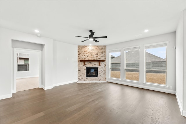 unfurnished living room with a fireplace, ceiling fan, and wood-type flooring