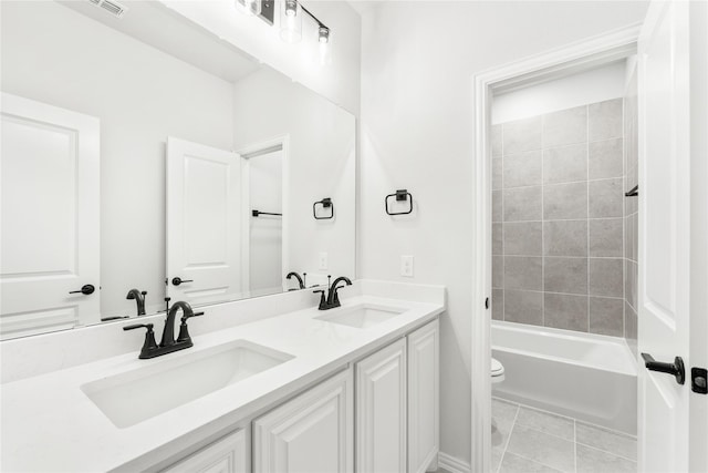 full bathroom featuring tiled shower / bath combo, toilet, tile patterned floors, and vanity