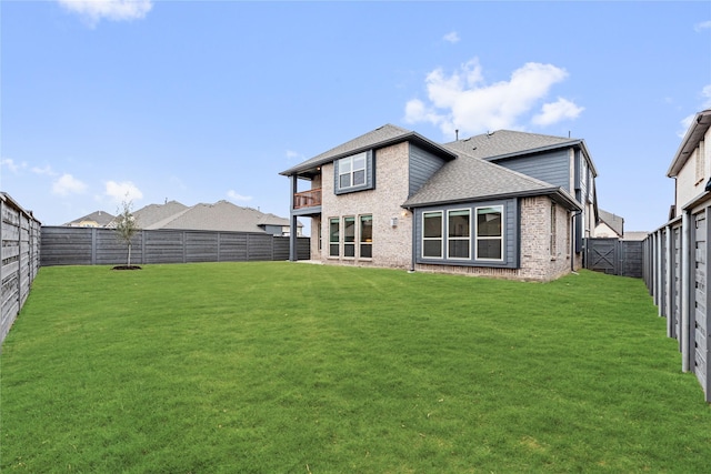 rear view of property featuring a lawn