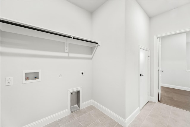 clothes washing area featuring light tile patterned flooring, gas dryer hookup, hookup for a washing machine, and electric dryer hookup