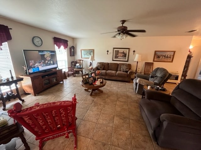 tiled living room with ceiling fan and plenty of natural light