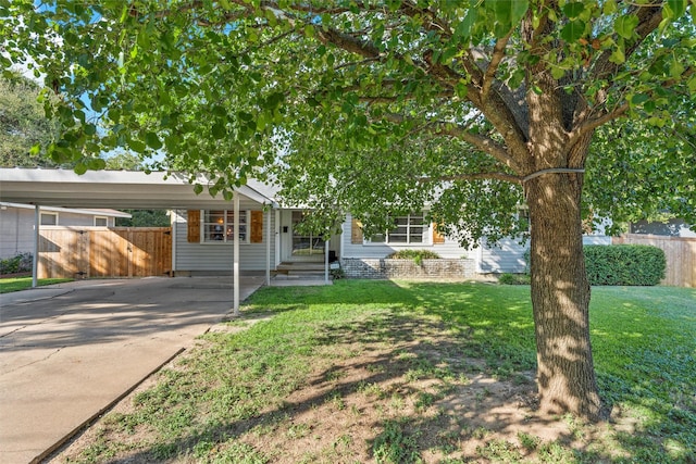 view of front of property with a front yard, driveway, and fence