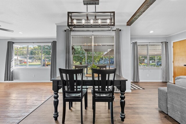 dining space with baseboards, ornamental molding, and a wealth of natural light