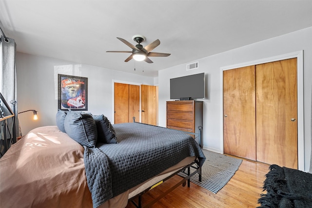 bedroom with a closet, visible vents, ceiling fan, and light wood-type flooring