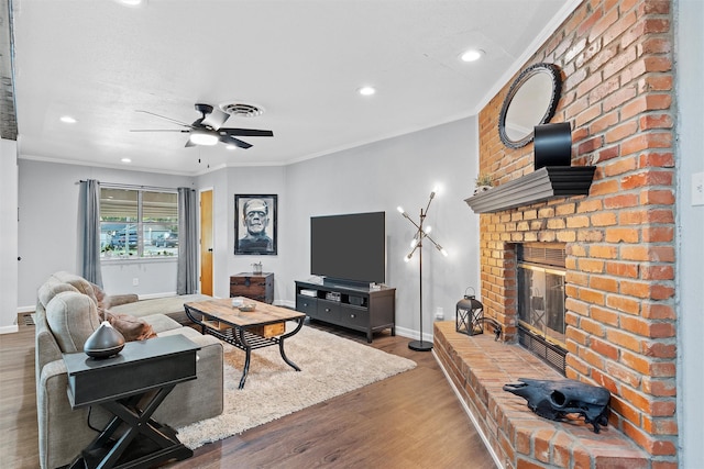 living room with recessed lighting, a fireplace, ceiling fan, baseboards, and wood finished floors