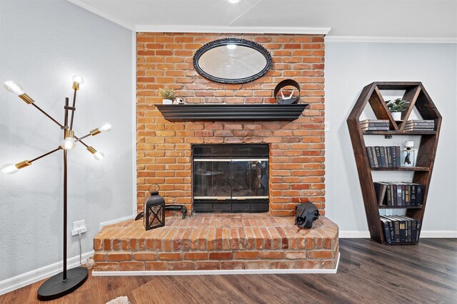 living room featuring crown molding, wood finished floors, and a fireplace