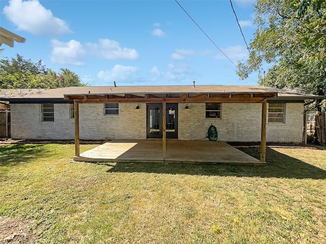 back of property featuring a patio and a lawn