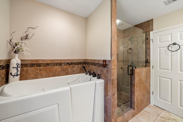 bathroom with plus walk in shower and tile walls