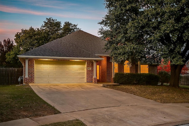 view of front of property with a garage and a yard