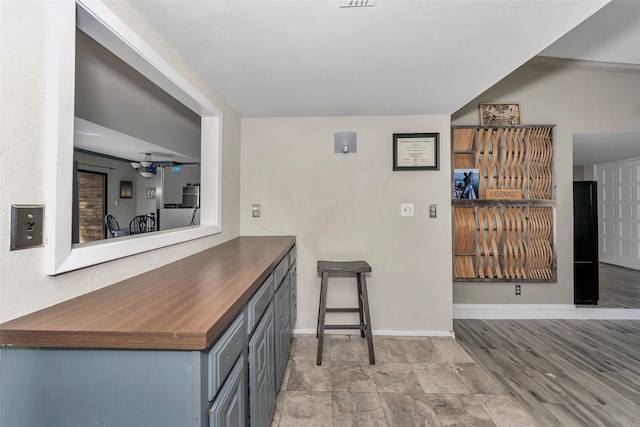 bar with gray cabinetry