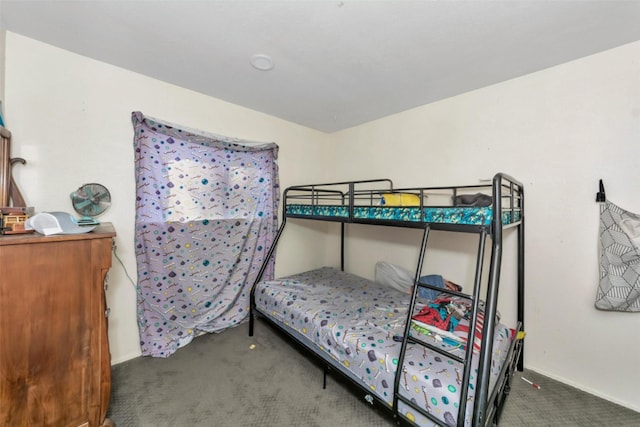 carpeted bedroom featuring baseboards
