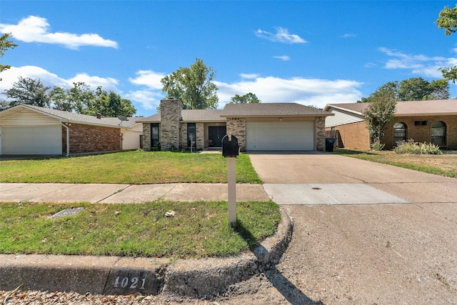 single story home featuring concrete driveway, brick siding, an attached garage, and a front yard