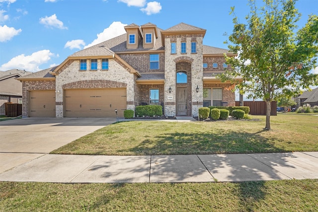 view of front of home featuring a front yard and a garage