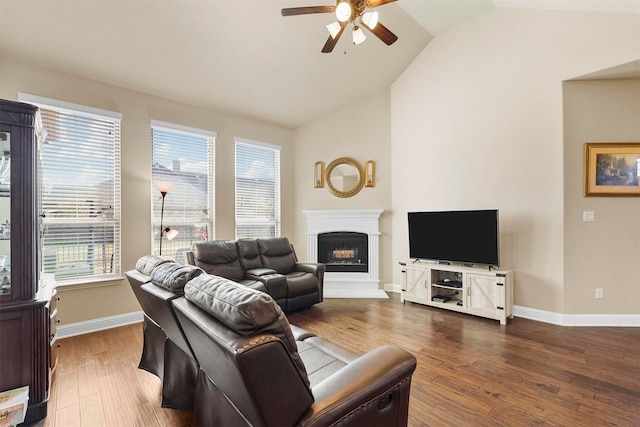 living room featuring lofted ceiling, dark wood-type flooring, and ceiling fan