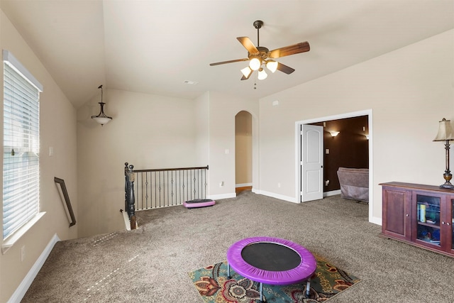 recreation room with ceiling fan, vaulted ceiling, and carpet floors