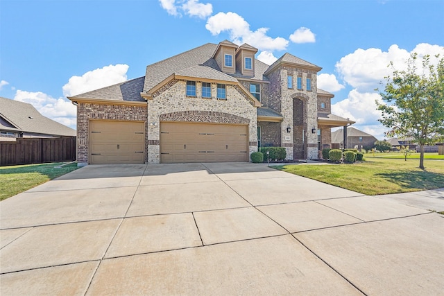 view of front of property featuring a front lawn and a garage