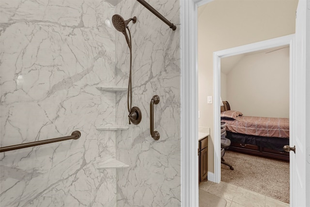 bathroom with vanity and tiled shower