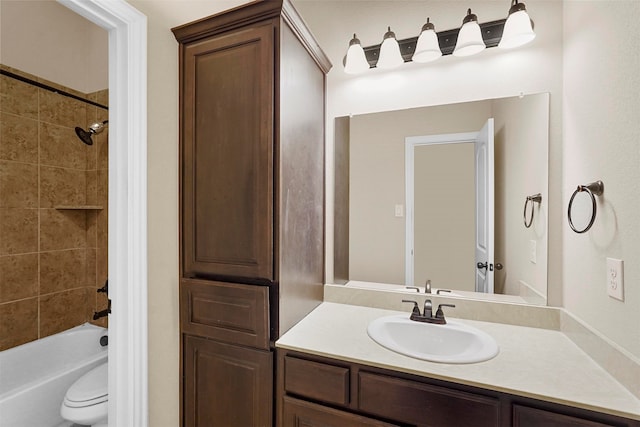 full bathroom featuring vanity, toilet, and tiled shower / bath