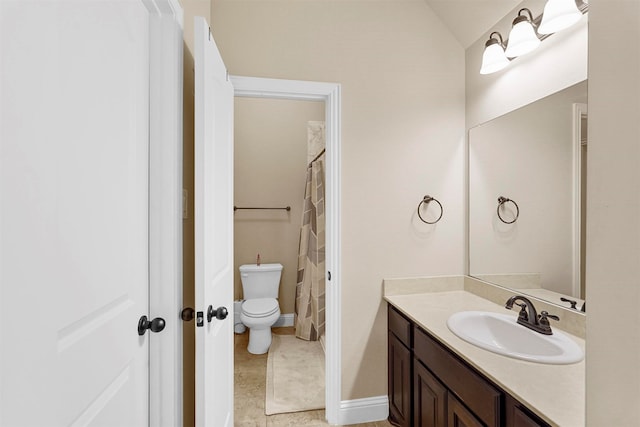 bathroom featuring vanity, toilet, and tile patterned floors