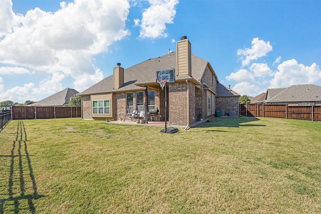 rear view of house featuring a yard and a patio area