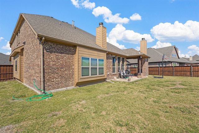 rear view of house featuring a yard and a patio area