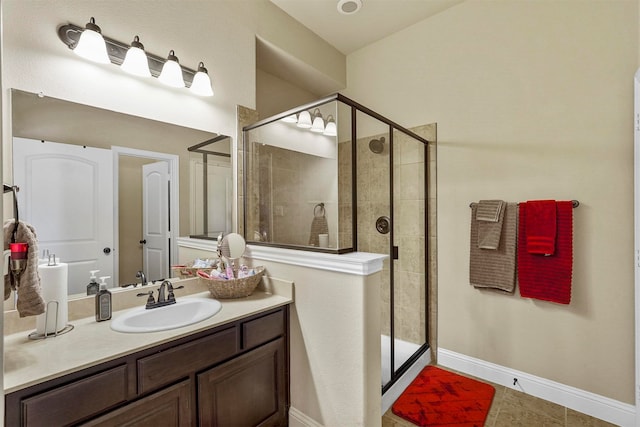 bathroom featuring vanity, a shower with shower door, and tile patterned flooring