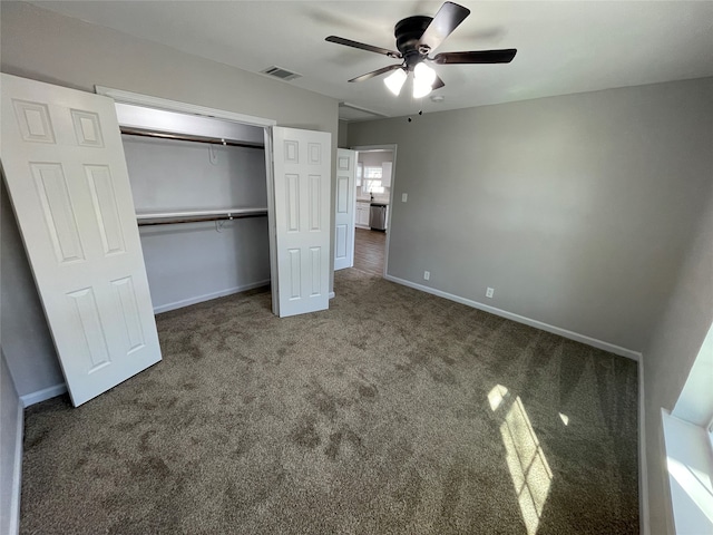 unfurnished bedroom with ceiling fan, carpet floors, and a closet