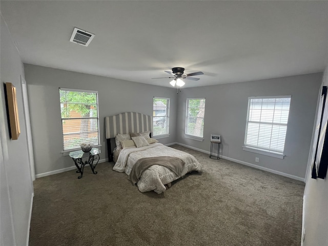 bedroom featuring ceiling fan, fridge, and dark colored carpet