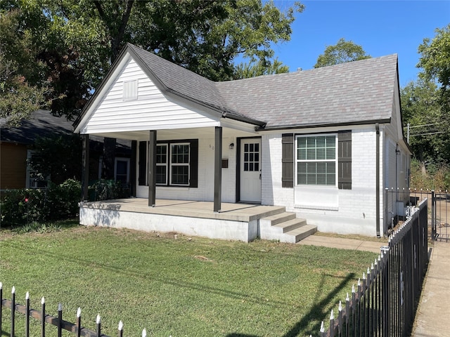 view of front of house featuring a front yard and covered porch