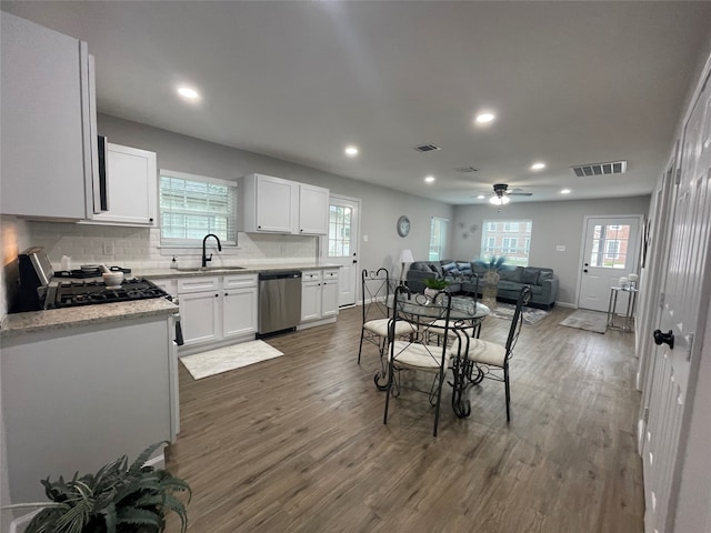 dining room with ceiling fan, dark hardwood / wood-style floors, plenty of natural light, and sink