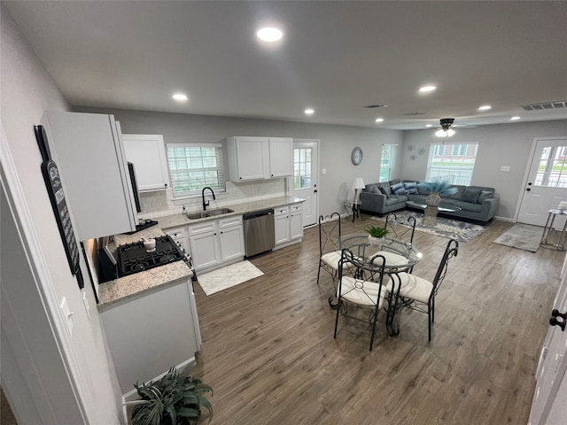 dining area with ceiling fan, sink, and dark hardwood / wood-style flooring