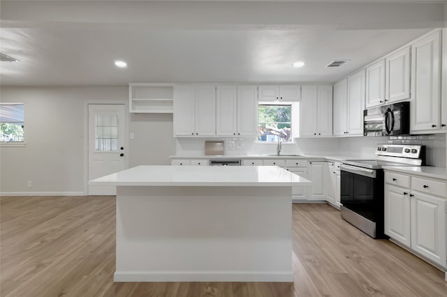 kitchen featuring appliances with stainless steel finishes, white cabinetry, and plenty of natural light