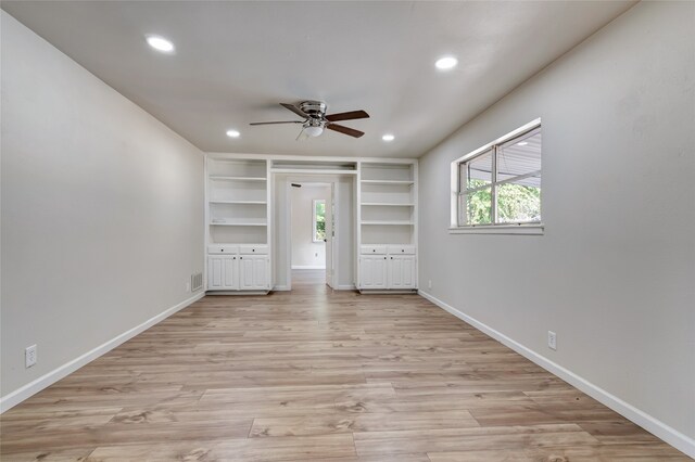 unfurnished bedroom with ceiling fan, light wood-type flooring, and multiple windows