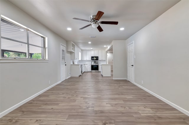 unfurnished living room featuring ceiling fan and light hardwood / wood-style flooring